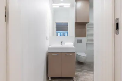 a bathroom with a sink and a toilet at Luksusowy apartament Świętego Jana na Rynku in Kraków