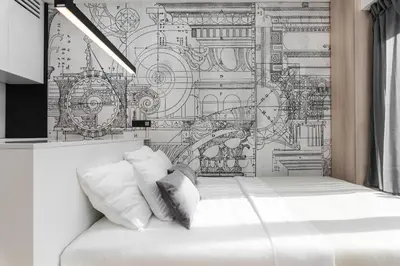 a bedroom with a drawing on the wall at White Room Piłsudskiego 1 in Kraków