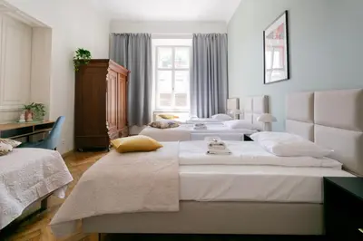 a group of four beds in a room at Apartments Studencka Street, Next to Planty Park in Kraków