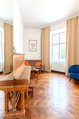 a living room with a piano and a couch at Apartments Studencka Street, Next to Planty Park in Kraków