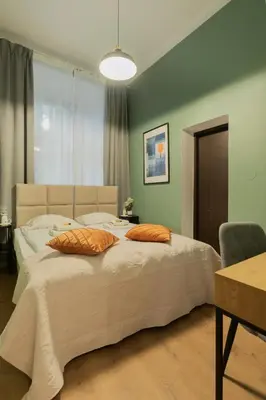 a bedroom with a large bed with two pillows on it at Apartments Studencka Street, Next to Planty Park in Kraków