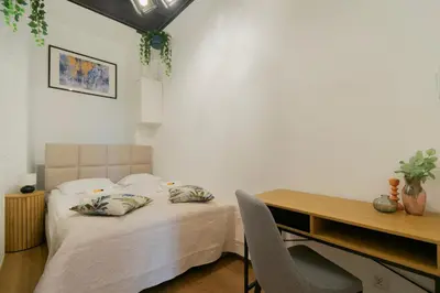 a bedroom with a bed with two pillows on it at Apartments Studencka Street, Next to Planty Park in Kraków