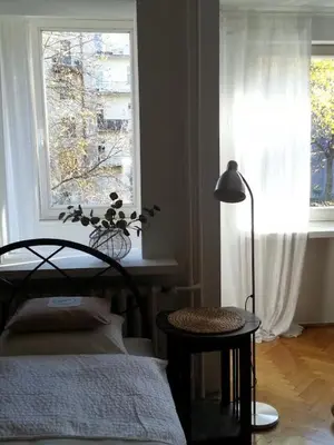 a bedroom with a bed and a window and a lamp at Pokój z widokiem in Kraków