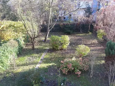 a garden with bushes and trees and a path at Pokój z widokiem in Kraków