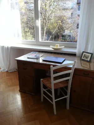 a desk with a chair in front of a window at Pokój z widokiem in Kraków