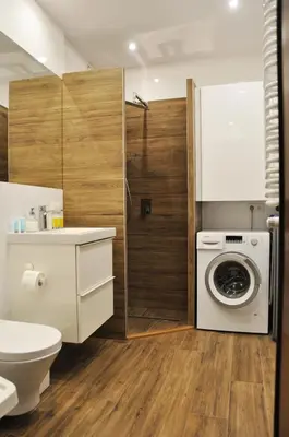 a bathroom with a toilet and a washing machine at Dworska 1A - studio by Homeprime in Kraków