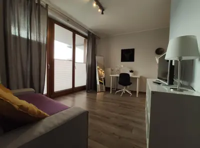 a living room with a couch and a television at Dworska 1A - studio by Homeprime in Kraków