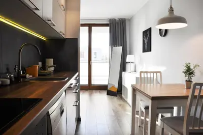 a kitchen with a sink and a table with a dining room at Dworska 1A - studio by Homeprime in Kraków