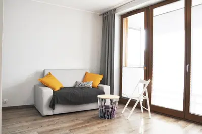 a living room with a couch and a chair at Dworska 1A - studio by Homeprime in Kraków