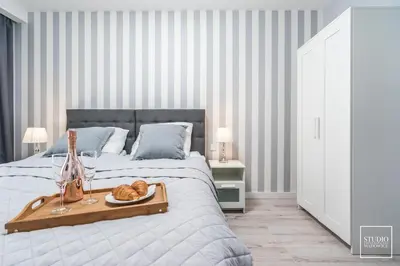 a bedroom with a bed with a tray of bread on it at Exclusive Vermelo Apartment in Kraków