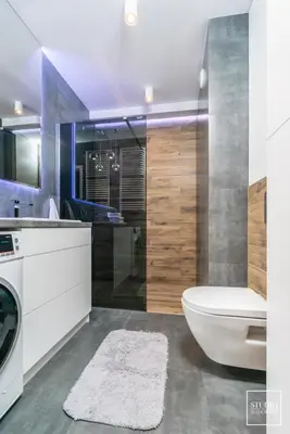 a bathroom with a toilet and a sink and a washing machine at Exclusive Vermelo Apartment in Kraków