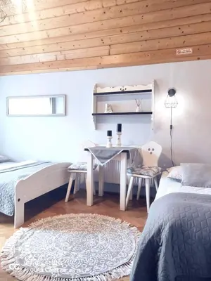 a bedroom with a bed and a table and chairs at Podkowa in Myślenice