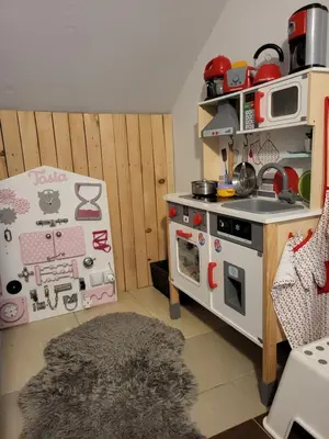 a kitchen with a toy stove and a refrigerator at Podkowa in Myślenice