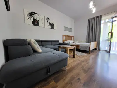 a living room with a couch and a table at Podkowa in Myślenice
