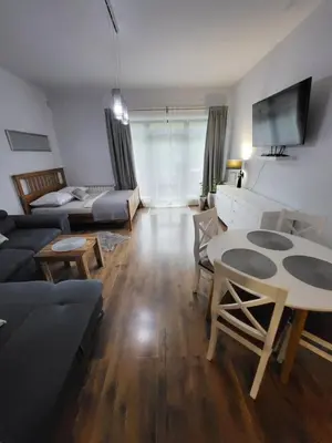 a living room with a couch and a table at Podkowa in Myślenice