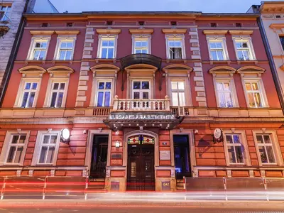a large building with a balcony on a street at Elegant Apartments in Kraków