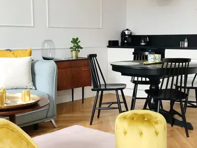 a living room with a couch and a table and chairs at TCF Home - Apartment with Free Garage in Kraków