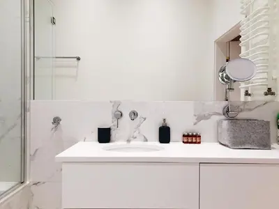 a white bathroom with a sink and a shower at TCF Home - Apartment with Free Garage in Kraków