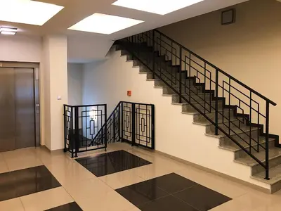 an empty lobby with stairs in a building at TCF Home - Apartment with Free Garage in Kraków