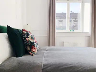 a bedroom with a bed with a pillow and a window at TCF Home - Apartment with Free Garage in Kraków