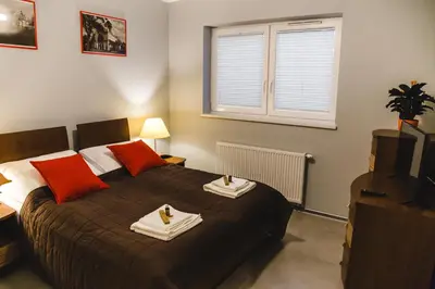 a bedroom with a bed with two towels on it at ULMA apartment in Wieliczka