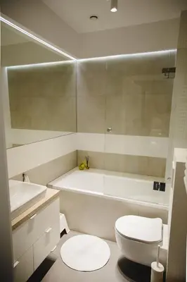 a bathroom with a toilet and a tub and a sink at ULMA apartment in Wieliczka