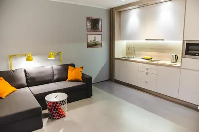 a living room with a couch and a kitchen at ULMA apartment in Wieliczka