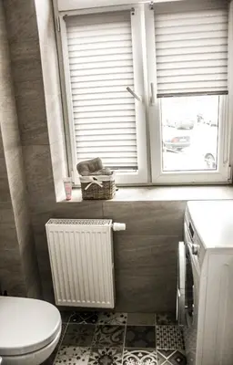a bathroom with a toilet and a window at Apartment Cracow in Kraków