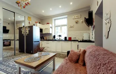 a kitchen with a couch and a table and a refrigerator at Apartment Cracow in Kraków