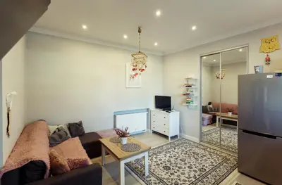 a living room with a couch and a refrigerator at Apartment Cracow in Kraków