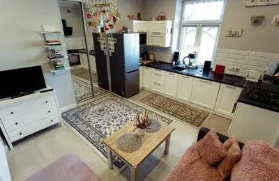 a kitchen with a refrigerator and a table in it at Apartment Cracow in Kraków