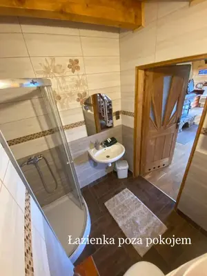 a bathroom with a sink and a shower at Górska Przystań in Wola Piskulina