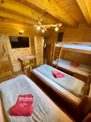 a room with two bunk beds in a cabin at Górska Przystań in Wola Piskulina
