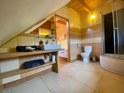 a bathroom with a toilet and a sink and a tub at Górska Przystań in Wola Piskulina