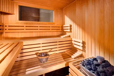 a wooden sauna with a bucket in the middle at Hotel Unicus Krakow Old Town - Destigo Hotels in Kraków