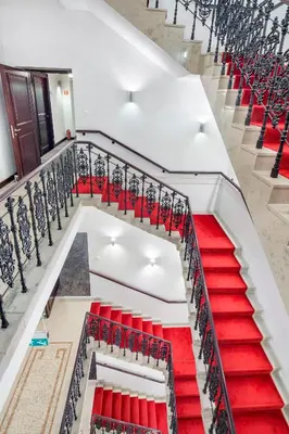 a set of red stairs in a building at Hotel Unicus Krakow Old Town - Destigo Hotels in Kraków