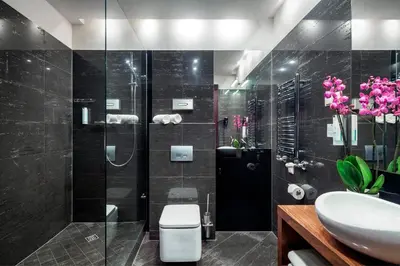 a bathroom with a shower and a toilet and a sink at Hotel Unicus Krakow Old Town - Destigo Hotels in Kraków