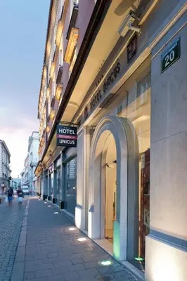a row of shops on a street in a city at Hotel Unicus Krakow Old Town - Destigo Hotels in Kraków