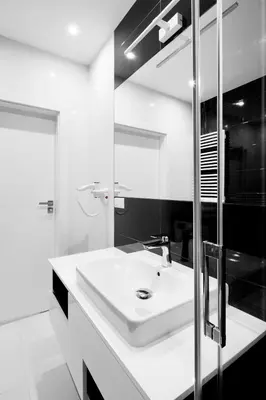 a white bathroom with a sink and a mirror at Native Apartments Lubelska 10 in Kraków