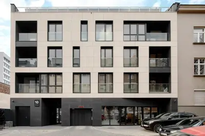 a large white building with a lot of windows at Native Apartments Lubelska 10 in Kraków