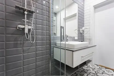 a bathroom with a sink and a shower at City of the Kings-Silver Apartment No 2- Lubelska 10 in Kraków