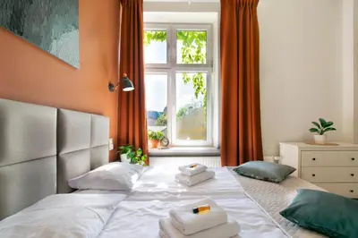 a bedroom with a large bed with towels on it at Vintage Apartment Gertrudy street in Kraków