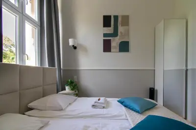a bedroom with a bed and a window at Vintage Apartment Gertrudy street in Kraków