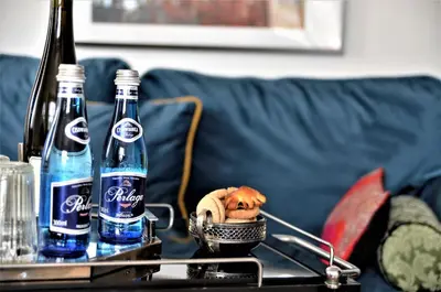two bottles of soda on a table in a living room at Castle View Boutique Apartment in Kraków
