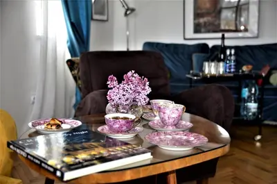 a coffee table with a bunch of dishes on it at Castle View Boutique Apartment in Kraków