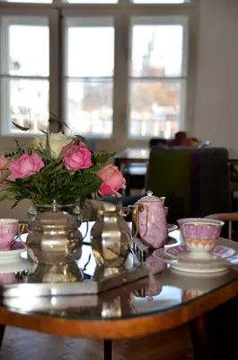 a table with a vase of flowers on top of it at Castle View Boutique Apartment in Kraków