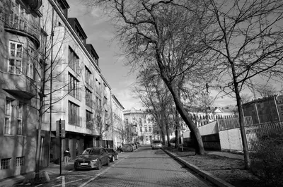 a black and white photo of a street with cars at Castle View Boutique Apartment in Kraków