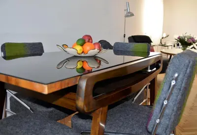 a table with a bowl of fruit on it at Castle View Boutique Apartment in Kraków
