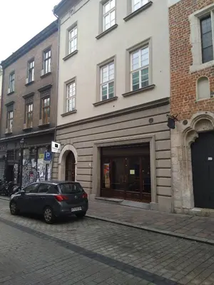 a black car parked in front of a building at Vinfort Aparthotel in Kraków