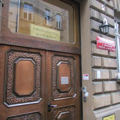a wooden door in a building with a sign on it at CDR in Kraków